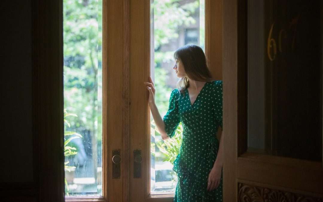 woman standing in front of french doors showcasing french door installation services